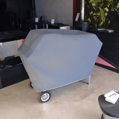 Grey heavy duty braai canvas cover fitted over a mobile grill unit.